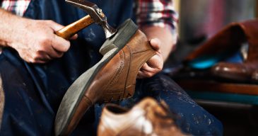 Close up of hands of old shoemaker